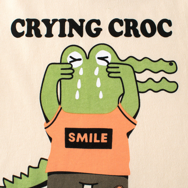 T-shirt pour enfant avec des manches courtes arborant un motif de crocodile.